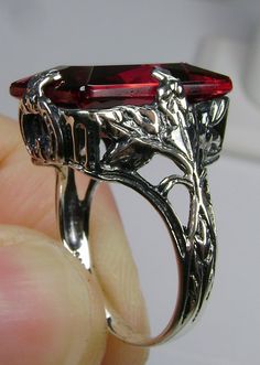 Simulated Ruby Ring GL Design#15 Made to Order This is a brand new 1930s reproduction solid sterling silver 925 floral leaf filigree approx. 10ct Simulated/man-made ruby gemstone ring. The inside of the band is hallmarked 925 for sterling. This rectangle-cut gemstone is 16mm (5/8th of an inch) by 12mm (1/2 inch) in size. Notice the beautiful leaf design of the silver filigree setting. This is an exquisite rendition of an antique filigree ring... and is ready to wear. A ring gift box is included. Red Rectangular Jewelry With Polished Finish, Red Victorian Engraved Jewelry, Red Art Deco Jewelry For Formal Occasions, Red Art Deco Hallmarked Jewelry, Red Art Deco Jewelry For Wedding, Art Deco Ruby Jewelry For Formal Occasions, Collectible Red Ruby Jewelry, Red Antique Collectible Jewelry, Art Deco Ruby Jewelry As A Gift