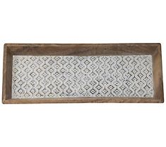 a wooden tray with an intricate design on the bottom and sides, holding a white doily pattern