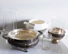 silver dishes and glasses on a white table