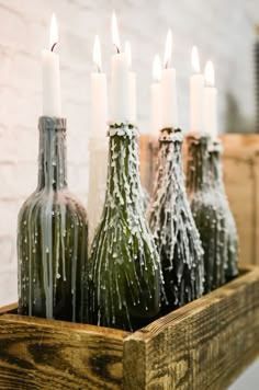 several bottles with candles in them sitting on a table