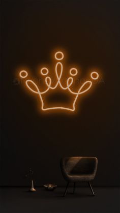 a neon crown on the wall next to a chair