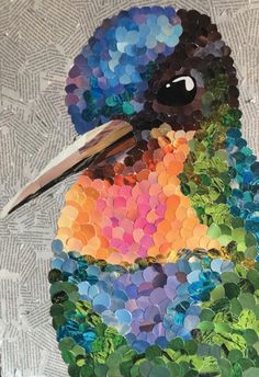 a colorful bird made out of buttons on a piece of paper with scissors in its beak