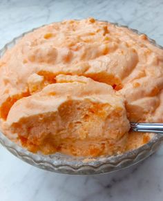 a close up of a bowl of food on a table with a spoon in it