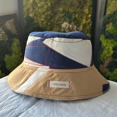 SIZE: Designed to fit sizes Large to X-Large; approximately 24 inches (refer to photos for sizing guidance). DESCRIPTION: Exquisitely crafted over 10 hours--featuring a deep Navy Blue, Sand blend, and complemented by touches of a rich Cranberry red fabric, meticulously sewn with premium threads. This distinct bucket hat exudes a maritime essence (aptly named for its colors). Its design is renowned and drapes gracefully. At TIHISI World, uniqueness is a guarantee! This is the SOLE hat of this design, ensuring its singularity. While elements of this pattern might reappear in future creations, this exact design remains unparalleled. Owing to the unparalleled and bespoke nature of this hat, coupled with the devotion and hours poured into its creation, we maintain a strict no-return policy. You Flipeez Action Hats, Paper Boat Hats, Deep Navy Blue, Bucket Hats, 5 Hours, Red Fabric, Cranberry, Caps Hats, Bucket Hat