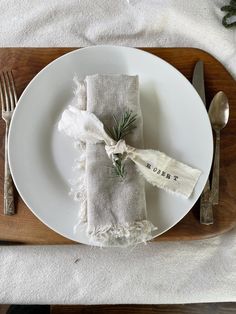 a white plate topped with a napkin and fork