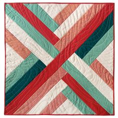 a red, green and white quilted wall hanging