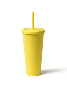 a yellow cup with a straw sticking out of it's lid on a white background