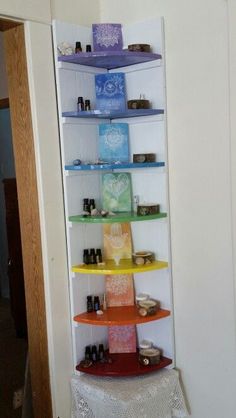 a shelf filled with lots of different items on top of a white table next to a doorway