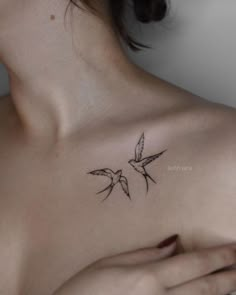 a woman's chest with two birds on it