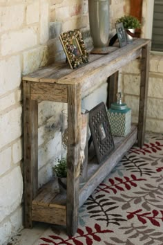 a wooden shelf sitting on top of a brick wall next to a potted plant