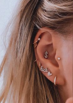 a close up of a person with ear piercings on their left side of the ear