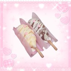 two ice creams on sticks with hearts in the background