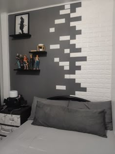 a bed room with a neatly made bed and two shelves on the wall above it