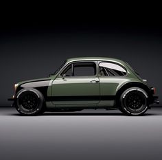 an old green car parked in a dark room