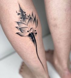 a woman's leg with a flower tattoo on it