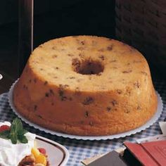 a cake sitting on top of a table next to plates with desserts around it