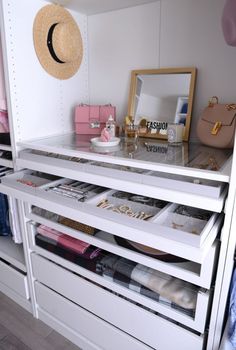 an organized closet with drawers and shelves filled with personal items, such as purses