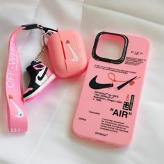 a pink phone case with a pair of scissors and a lanyard attached to it