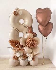 balloons are arranged in the shape of an eight, with flowers and leaves on them