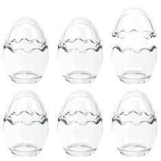 six clear glass vases with wavy lines on the top and bottom, each filled with water