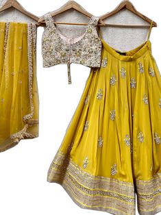 Designer Gold Georgette Lehenga, Designer Georgette Gold Lehenga, Gold Georgette Sets For Festivals, Gold Choli With Dori Work For Navratri, Festival Georgette Sets In Gold, Gold Dola Silk Palazzo Set With Mirror Work, Chinon Lehenga With Dori Work For Navratri, Navratri Lehenga With Dori Work And Chinon Material, Navratri Lehenga With Dori Work In Chinon