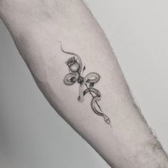 a man's arm with a snake tattoo on it