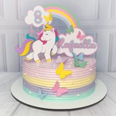 a birthday cake decorated with butterflies and a unicorn