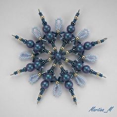 a snowflake made out of beads and pearls