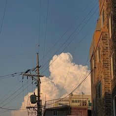 the sky is very cloudy and it looks like clouds are coming out of the building