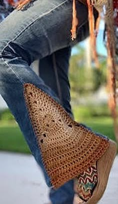 a woman's legs and handbag hanging from a tree