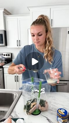 a woman is mixing ingredients in a blender