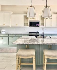 two stools sit at the center of a kitchen island