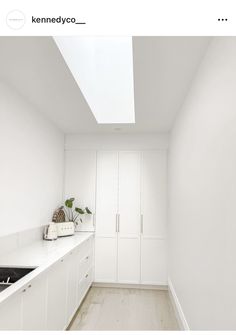 an empty kitchen with white cabinets and wood flooring is seen in this instagram