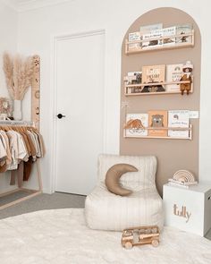 a baby's room with a rocking chair, bookshelf and other items