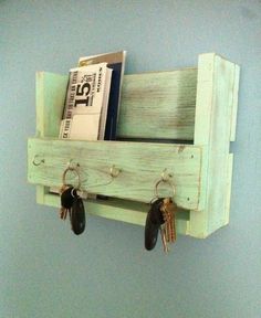 a wooden shelf with key hooks and some books