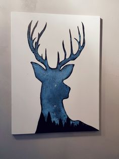 a painting of a deer with antlers on it's head is hanging on the wall