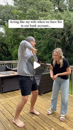 a man and woman standing on a wooden deck with a sign above them that says, acting like you're when you have got 50 % in our bank account