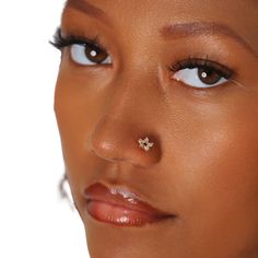 a close up shot of a woman's nose and nose piercing