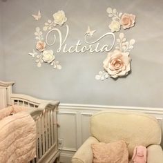 a baby's room with a crib, rocking chair and wall hangings