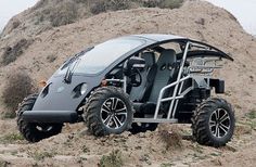 an off - road buggy is parked in the sand on top of a hill