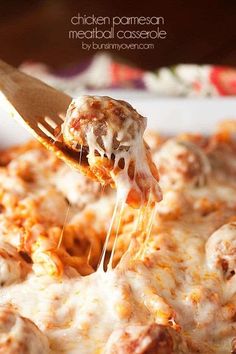 a close up of a person holding a spatula with some food on it and the words chicken parmesan meatball casserole