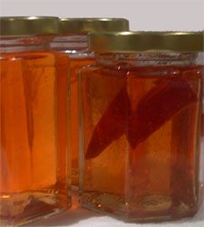 two jars filled with liquid sitting next to each other