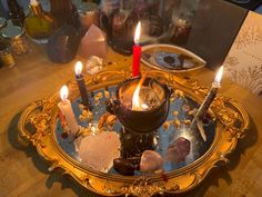 three candles are lit in an ornate tray