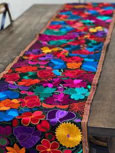 a long table runner with colorful flowers on it