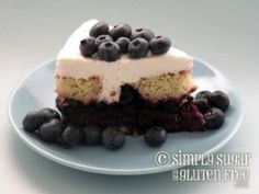 a piece of cake with blueberries and cream frosting