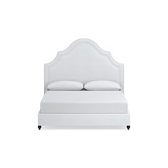 a white bed with an upholstered headboard and foot board on the side