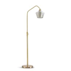 a gold floor lamp with a clear glass shade