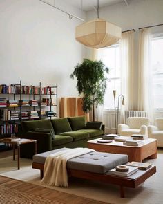 a living room filled with furniture and bookshelves