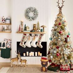 a decorated christmas tree with stockings hanging from it's sides in front of a fireplace