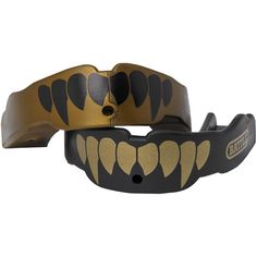 two black and gold bracelets that have teeth on each side, one with an open mouth